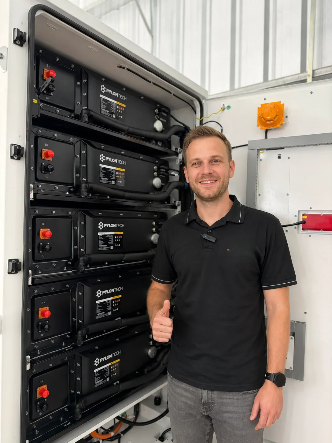 Engineer inspecting a Pylontech liquid-cooled ESS battery rack